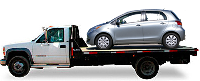 Toyota Yaris riding on top of flatbed truck
